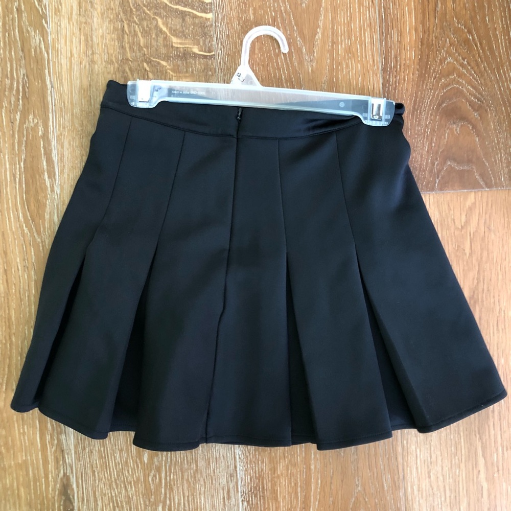 Black pleated woman’s skirt.